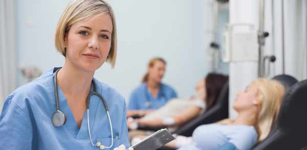 Female Registered Nurse Poses for Photo by Hospital Patient